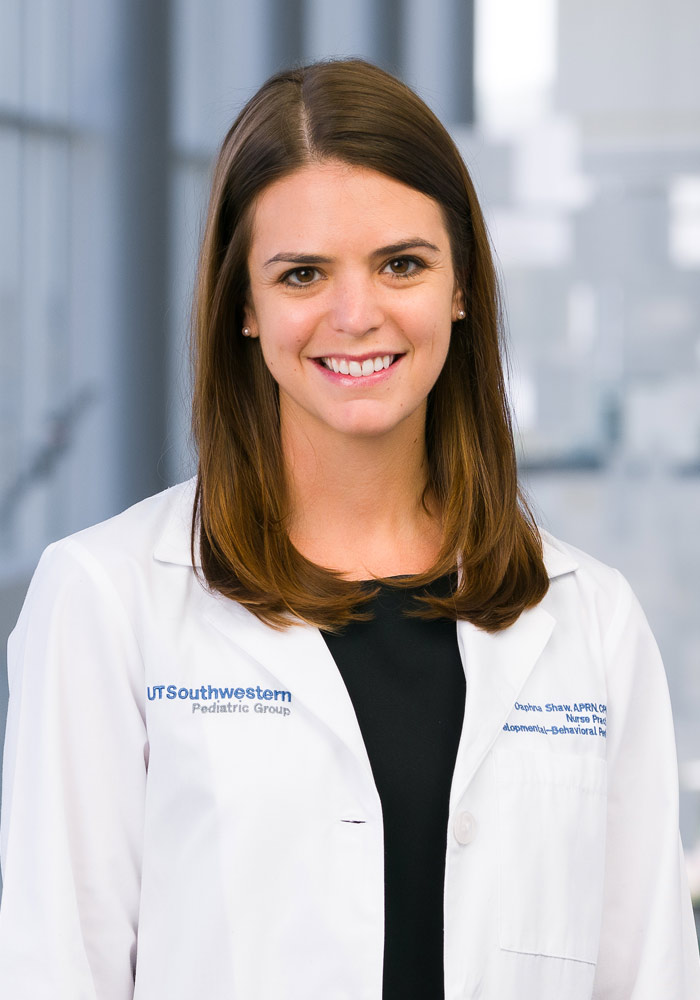 Woman with long dark hair wearing a white lab coat