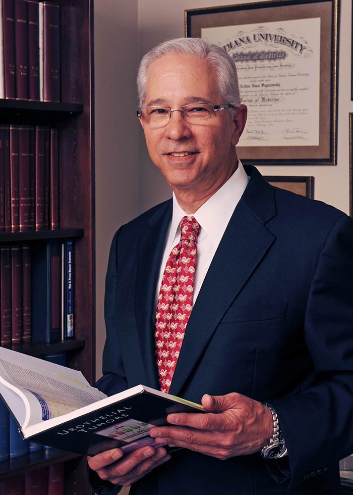 Man holding book while wearing dark blue suit