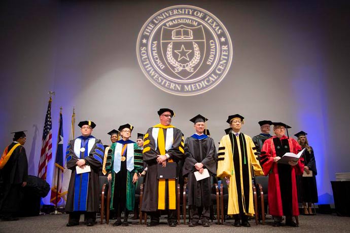 Academic leaders in black graduation gowns
