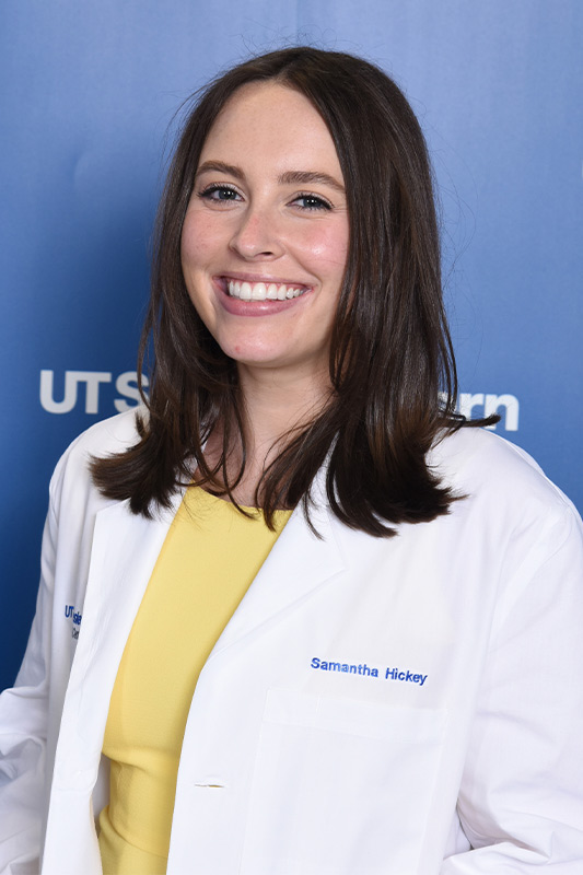Woman with short straight brown hair, white lab coat