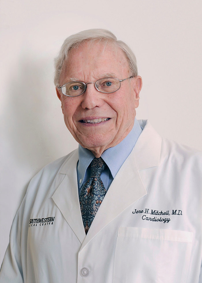 Man with white hair in white lab coat