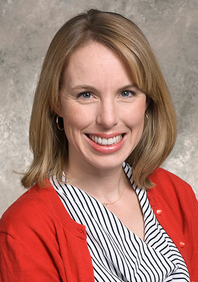 Woman wearing striped shirt and red jacket