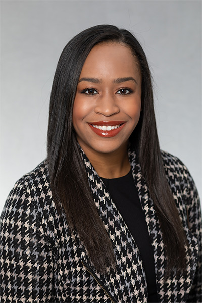 woman with black and grey checked jacket and long straight black hair