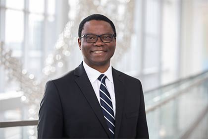 headshot of Samuel Achilefu, M.D. wearing glasses and dark suit