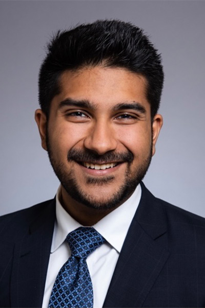 Man wearing blue suit with light blue checkered tie