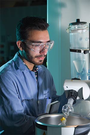 man in blue shirt holding test tube