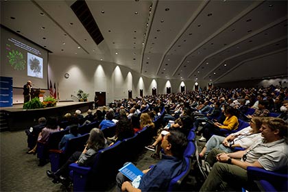 man on stage while audience views