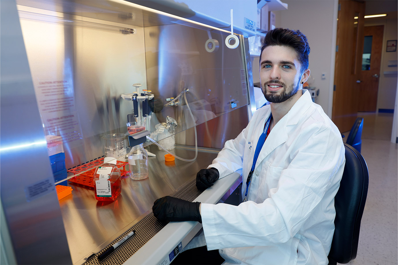 man at desk wearing white lab coat