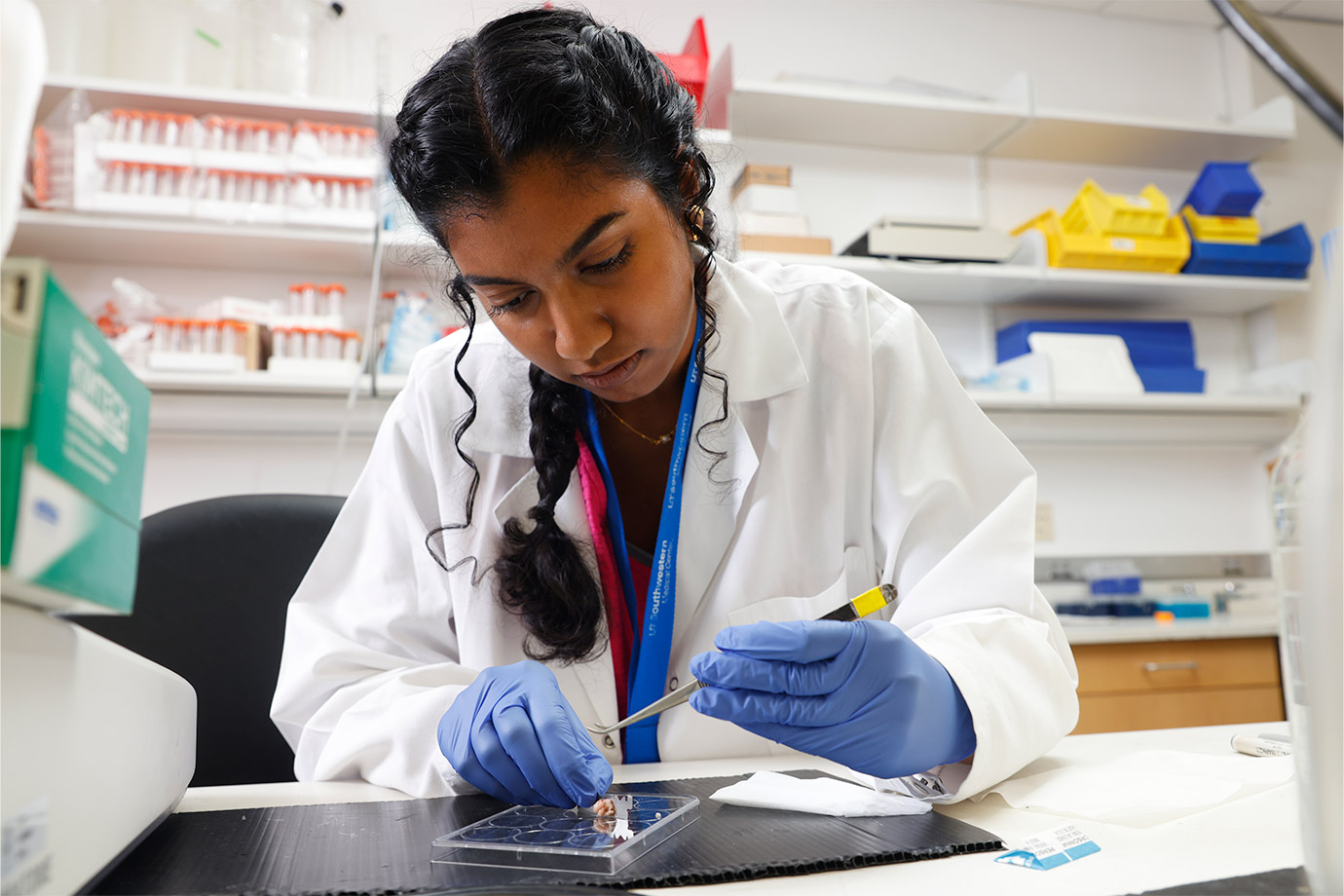 woman at desk performing experiment