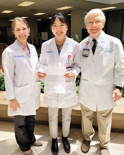 three doctors in white lab coats