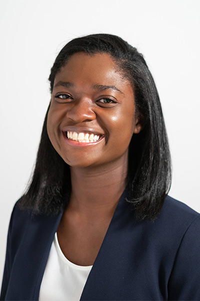 Woman wearing navy blazer and white shirt