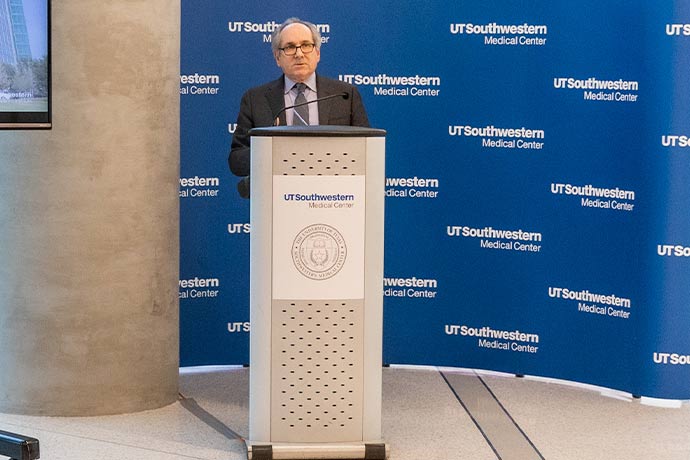 man in dark suit at podium 