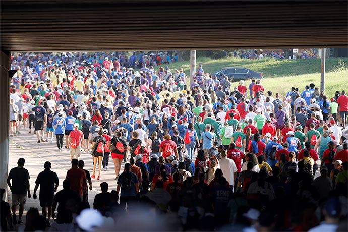 people walking under tunnel