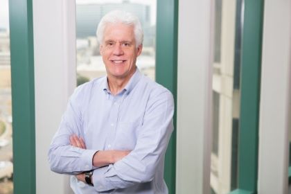 smiling man with white hair