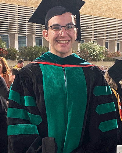man wearing green and black graduation robe