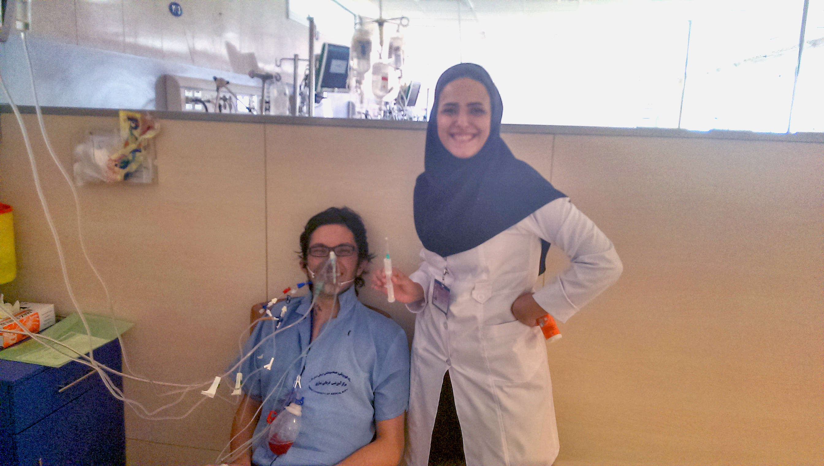 man in hospital gown with woman in lab coat