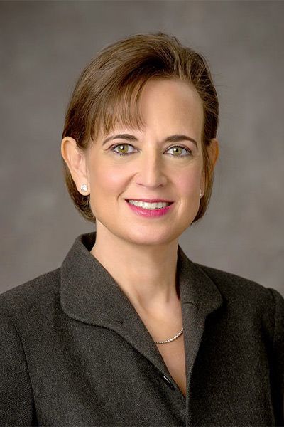 woman in dark brown suit, dark hair
