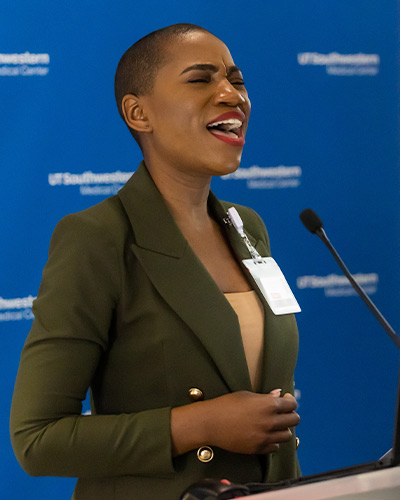 woman singing at podium