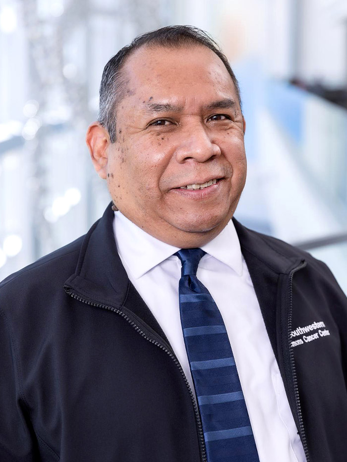 man wearing blue jacket, white shirt, and blue striped tie