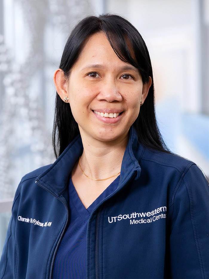 woman in blue scrubs, blue jacket, dark hair