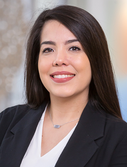 woman with straight, long, dark hair, white blouse, black blaze