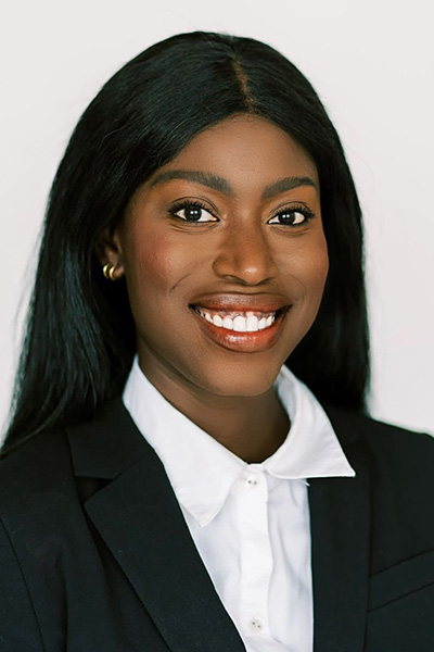 woman with straight dark hair, white shirt, dark jacket