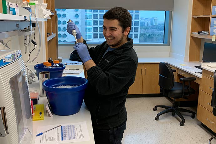 man in lab with blue bucket