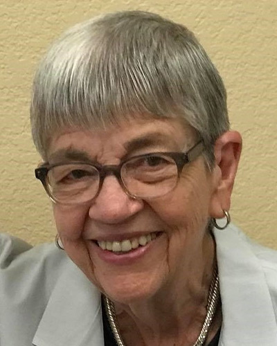 woman with silver hair and glasses