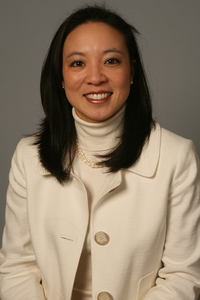 woman in cream coat and turtleneck, dark hair