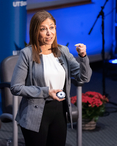 woman in black slacks, white shirt, black and white blazer