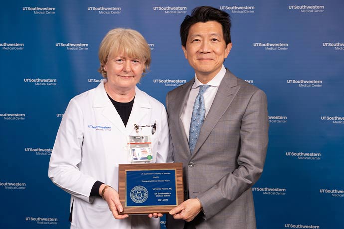 woman in black shirt, white lab coat, blonde hair