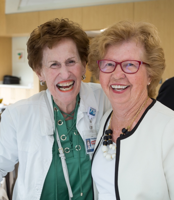 Jeanette Lynch, UT Southwestern volunteer, hugs fellow volunteer