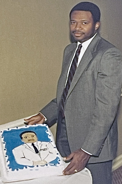 Dr. James Griffin cuts cake at graduation celebration in 1986