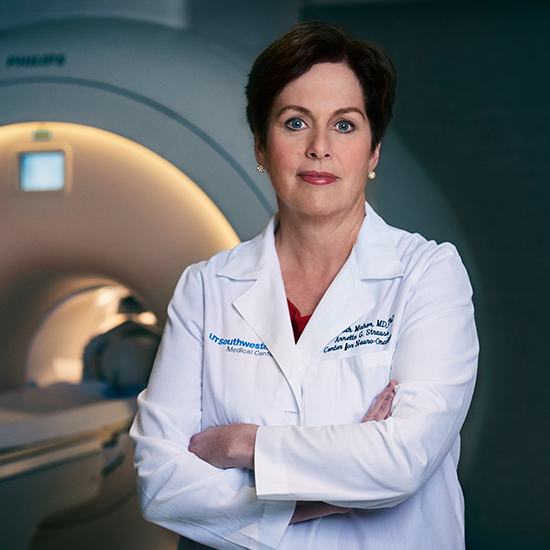 Dr. Maher standing next to a CT Scan machine.