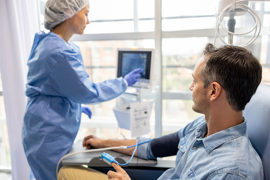 Nurse taking a patients heart rate.