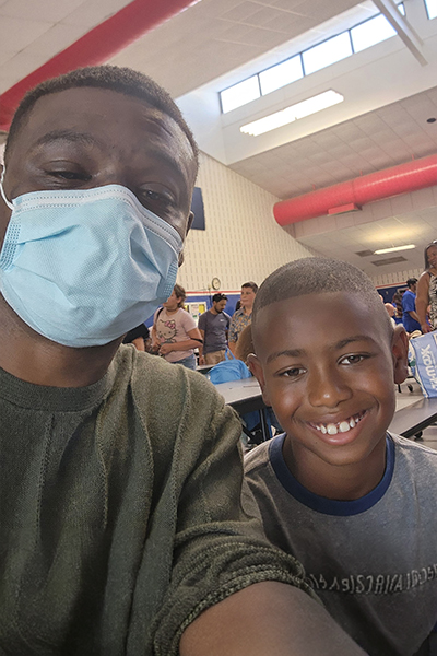 patient in mask celebrates successful surgery with his son at UTSW