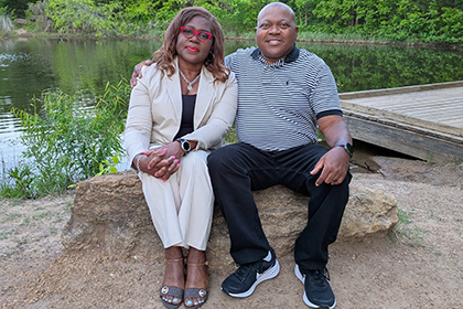 Man and woman sitting on a stone.