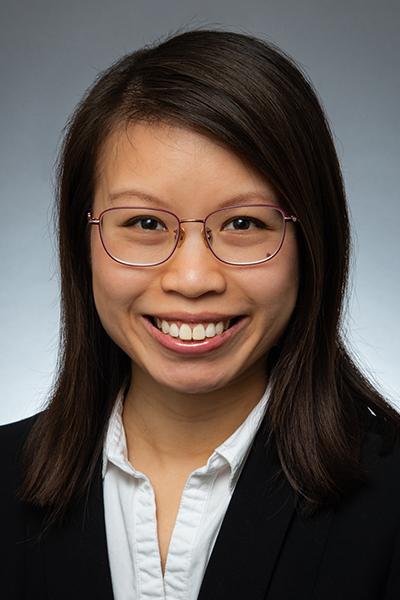 Hannah Chang headshot, woman with long dark hair wearing glasses, black jacket, white collared shirt