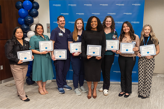 Eight nurses show their certificates. 