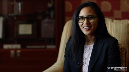 Woman seated and speaking into camera