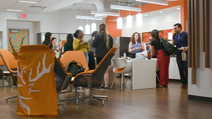 several students stand in commons area