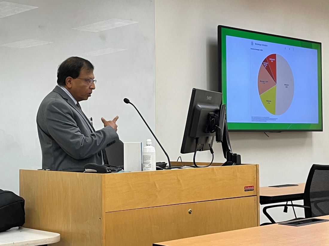 Dr. Bhaskar Padakandla speaking at podium