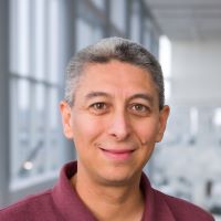 Latino Man wearing maroon colored shirt