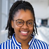 African American woman wearing blue and white striped blouse with glasses