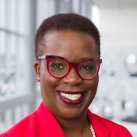 african american woman wearing red blouse and glasses