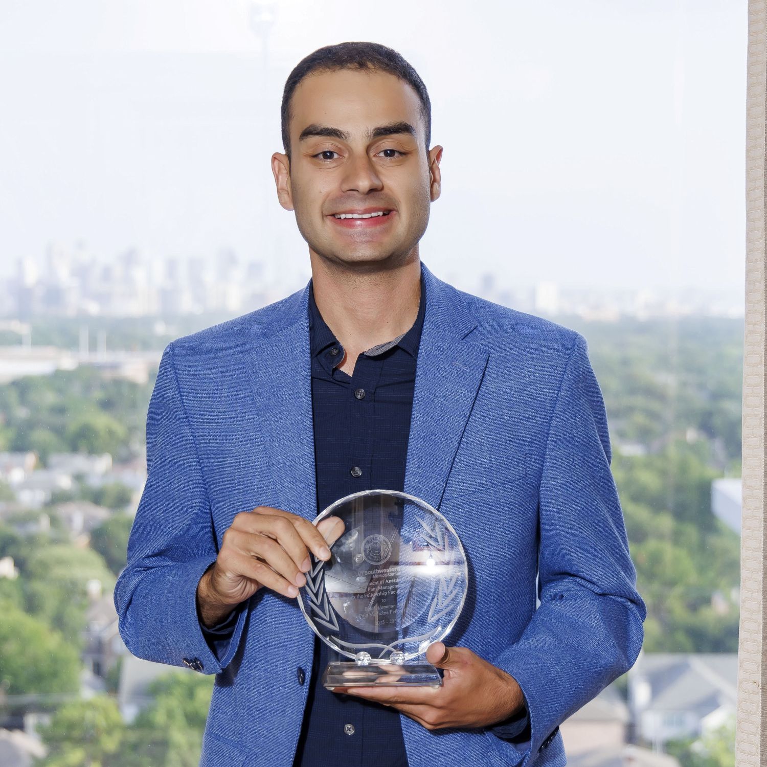 Belal Alammar, M.D. holding award