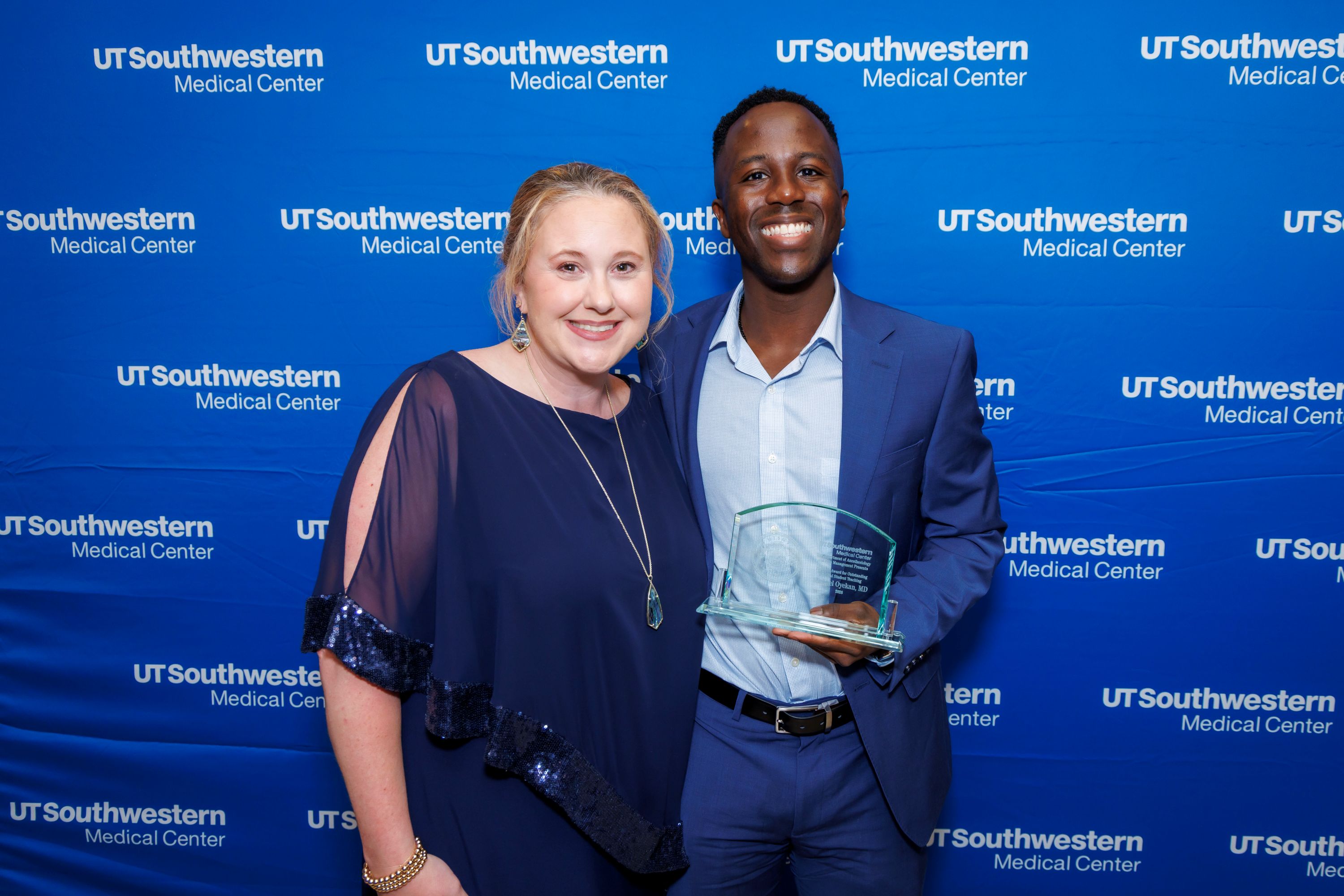 Michael Oyekan, M.D., holding award with Amy Woods, M.D.