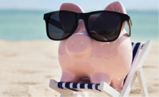 Piggy bank with sunglasses, sitting on a beach