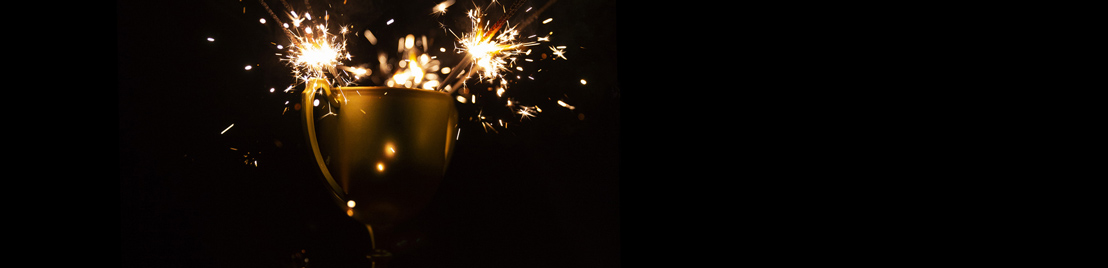 Fireworks shoot from a gold trophy