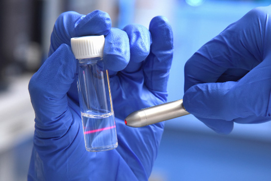 Gloved hands holding a test tube